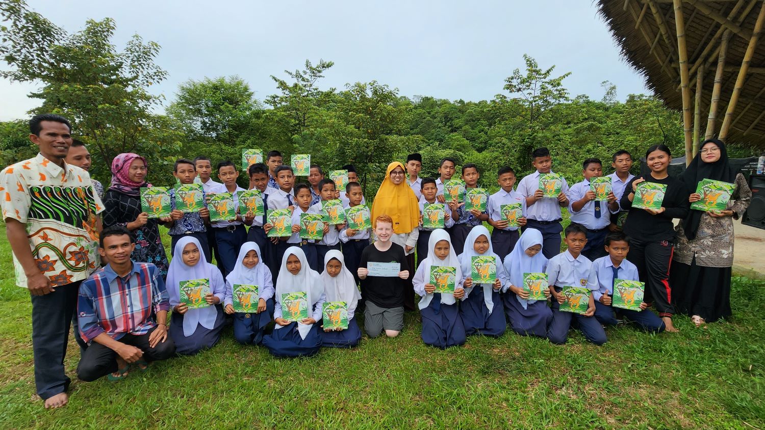 Jack gives a donation of books in Indonesia